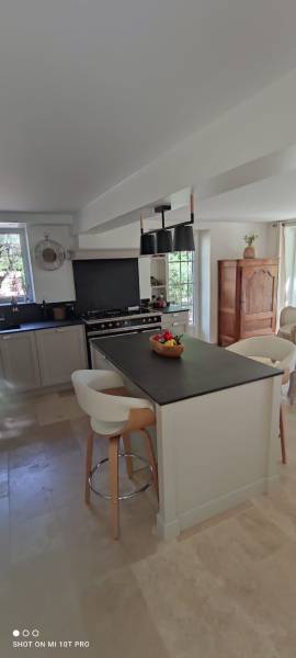 Conception et installation de cuisine classique sur mesure avec aménagement astucieux sous escalier pour optimiser l'espace dans les maisons de village du Vaucluse